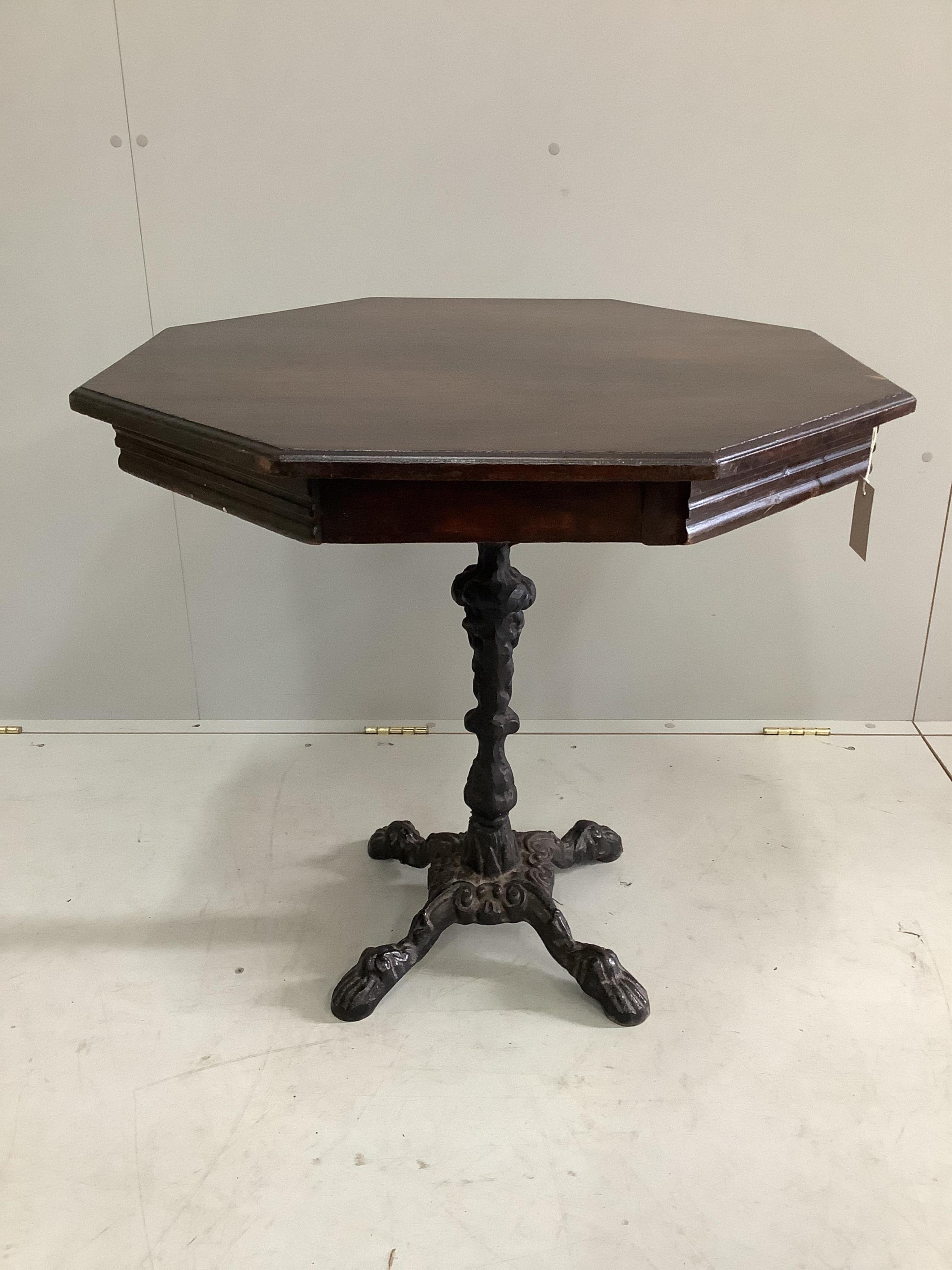 A late Victorian octagonal mahogany and cast iron centre table, width 75cm, height 72cm. Condition - fair